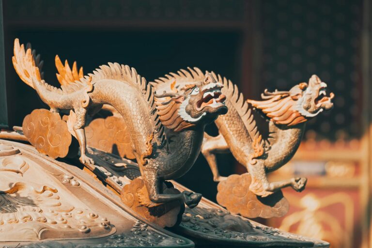 Detailed close-up of ancient eastern dragon sculptures with rich historical texture.