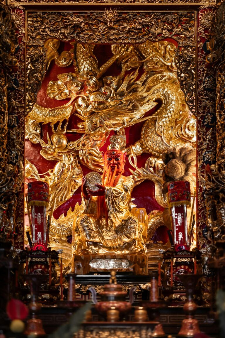 Detailed gold dragon relief in a traditional Chinese temple interior, showcasing cultural artistry.